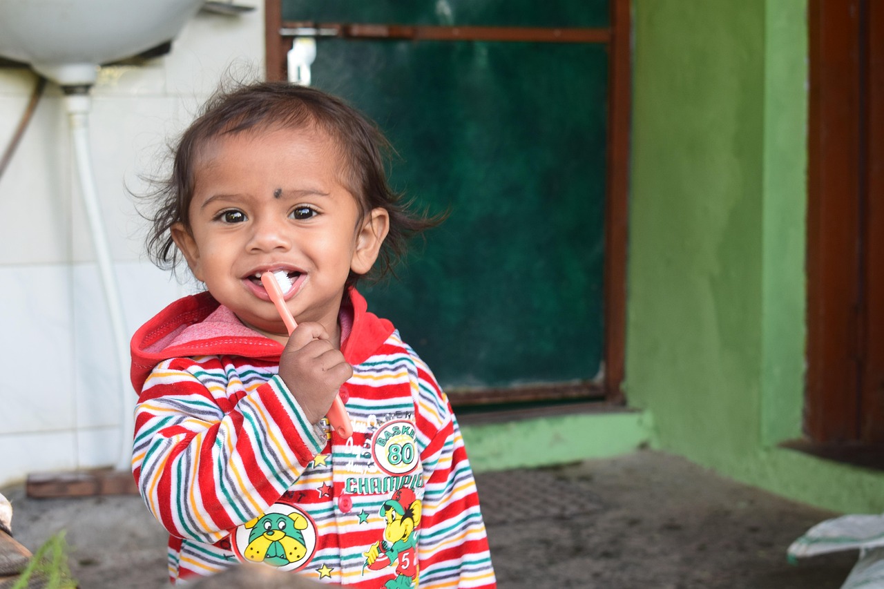 Enfant qui se brosse les dents devant un miroir